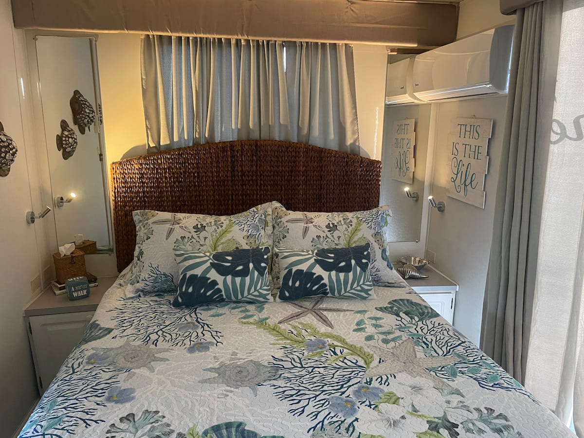 Cozy queen bedroom aboard Island Time with coastal decor