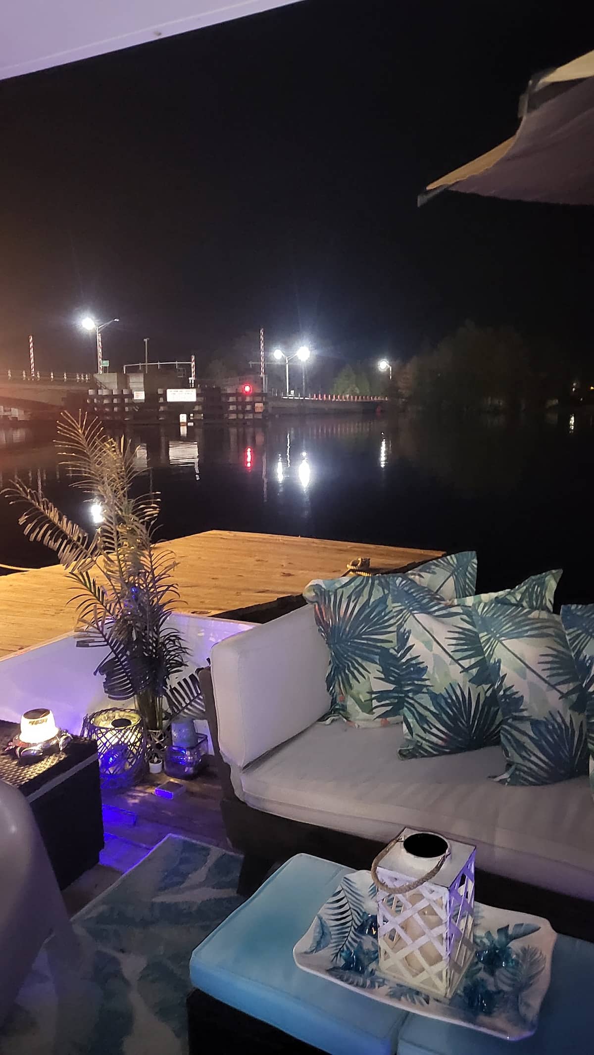 Cozy private deck seating overlooking the marina at night
